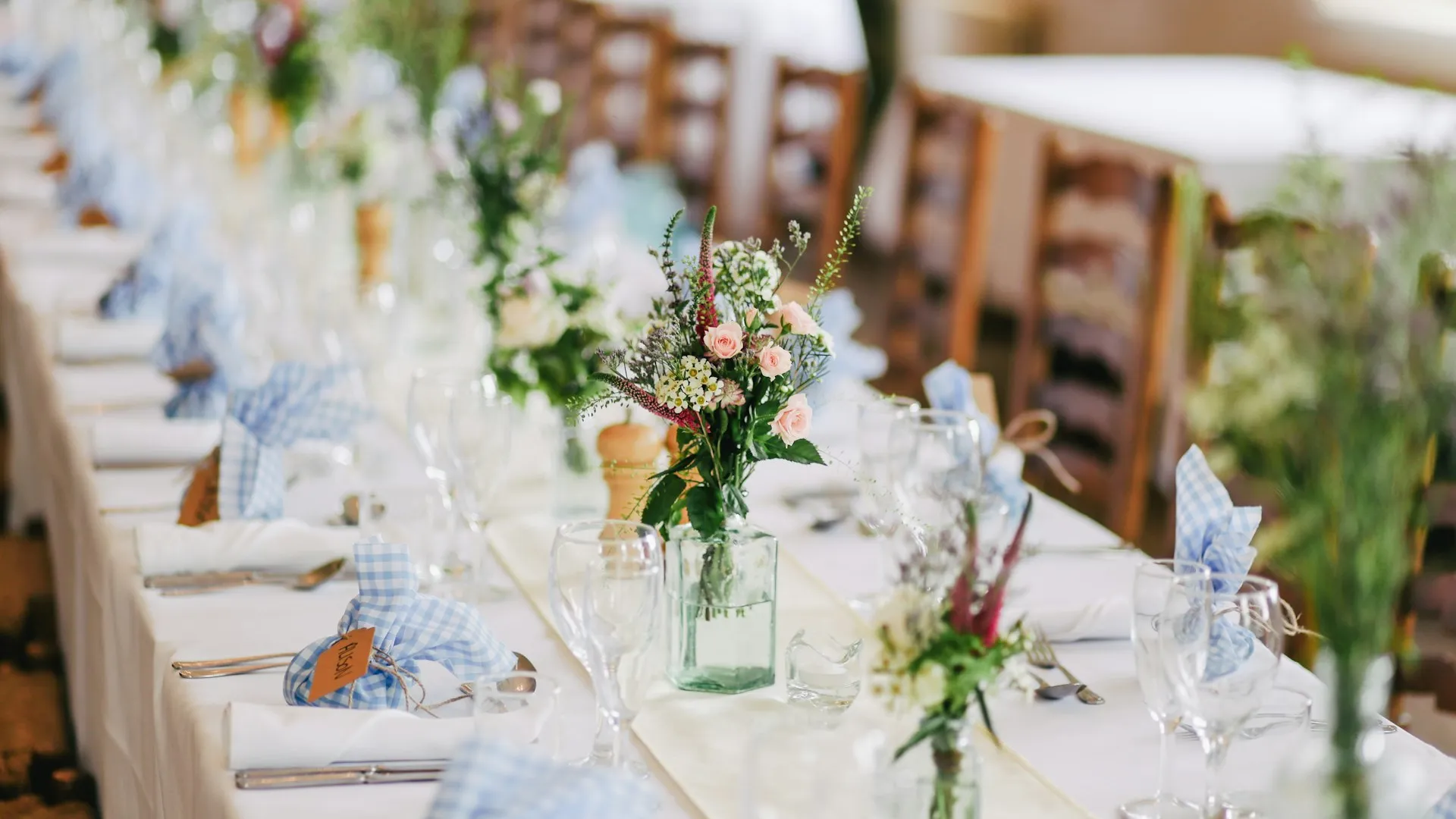 Elegante recepción de boda con iluminación cálida y mesas decoradas con flores